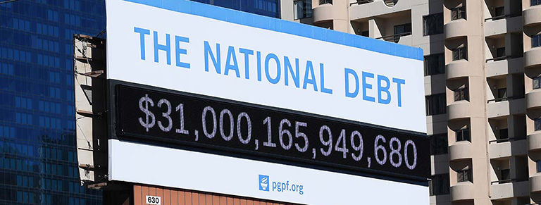 National Debt billboard displaying $31 trillion. 
