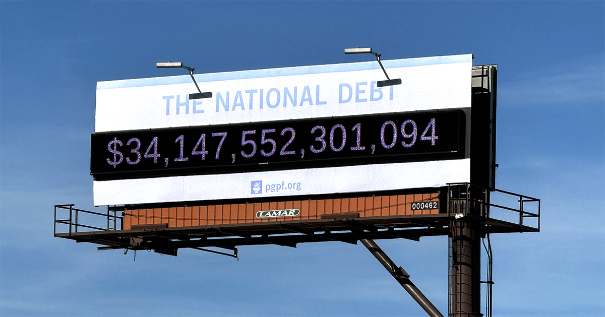 Image of billboard displaying $34 trillion in national debt. 