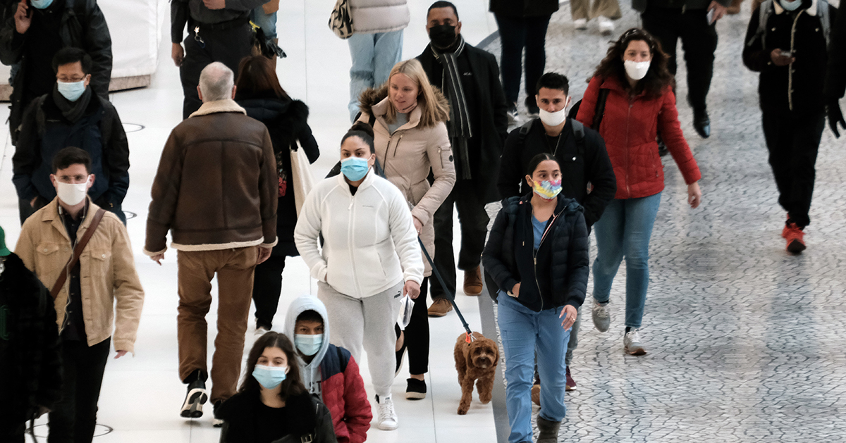 People in a mall wearing masks 