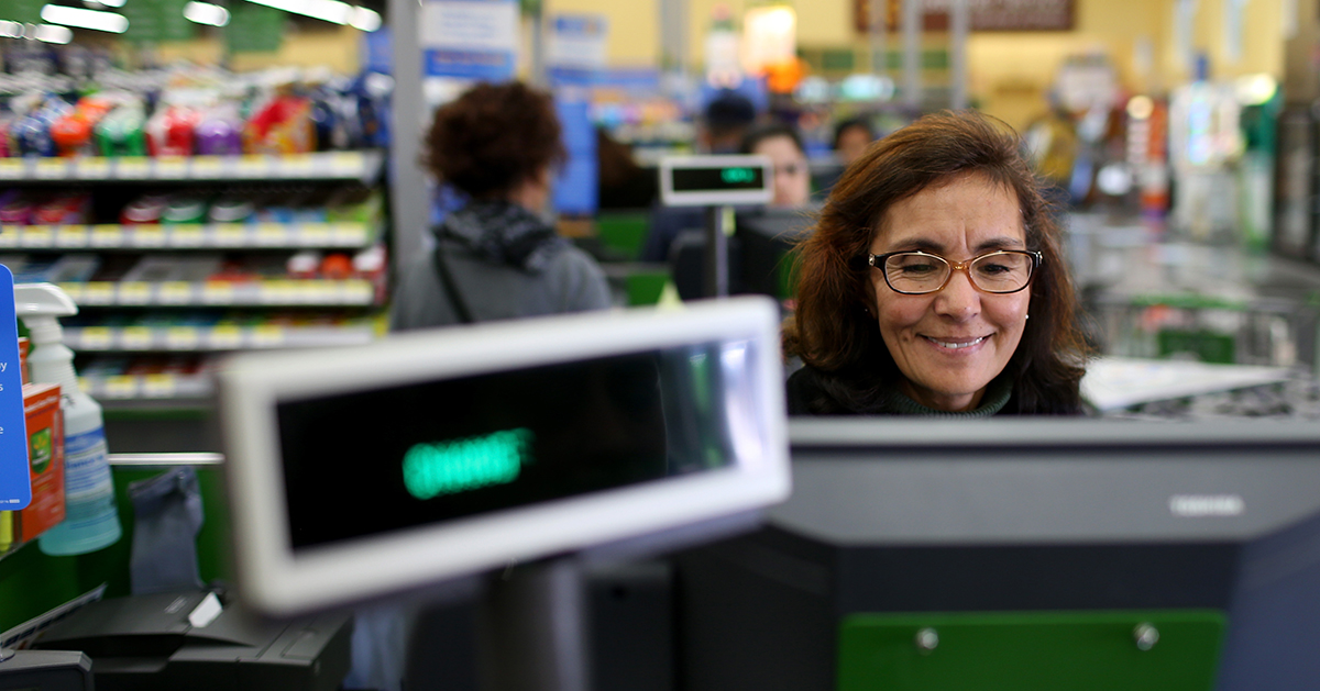 Older American behind a cash register