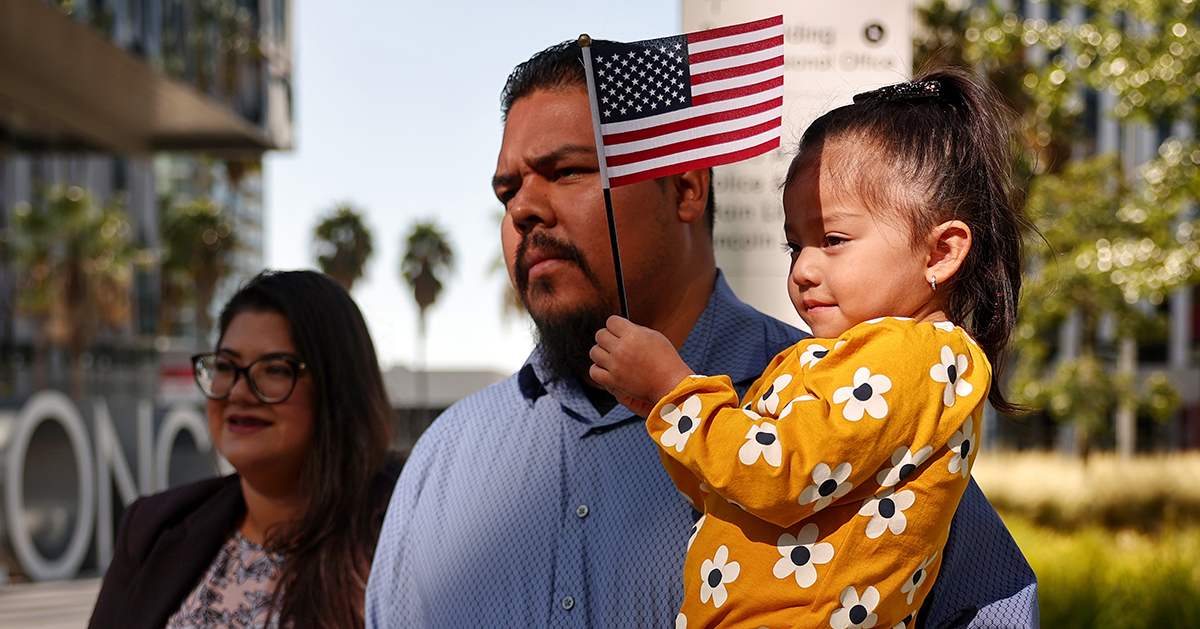 Image of a family with child holding an American flag
