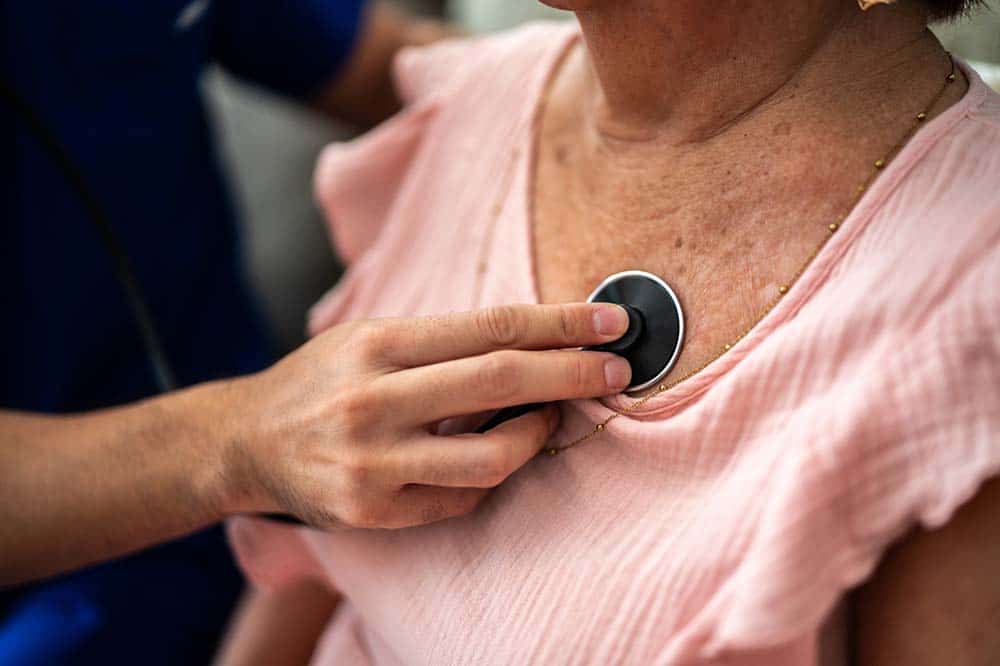 Doctor listening to patient's heart with a stethoscope