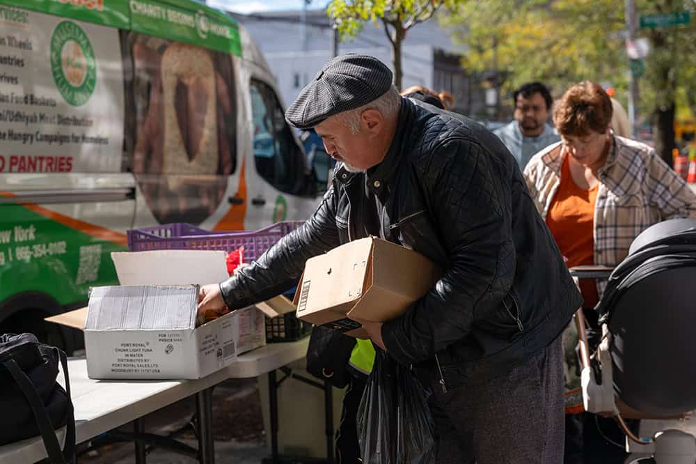 Older American in line receiving assistance at a food bank.