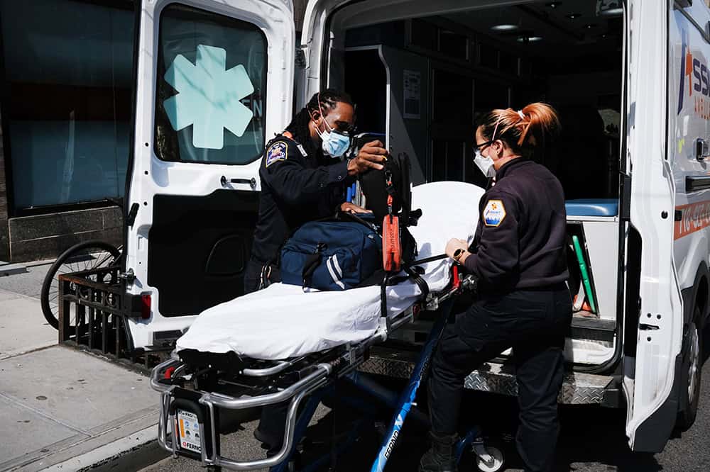 Ambulance workers clean a gurney
