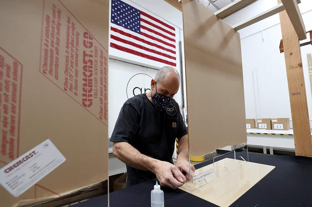 Worker assembles acrylic sheets