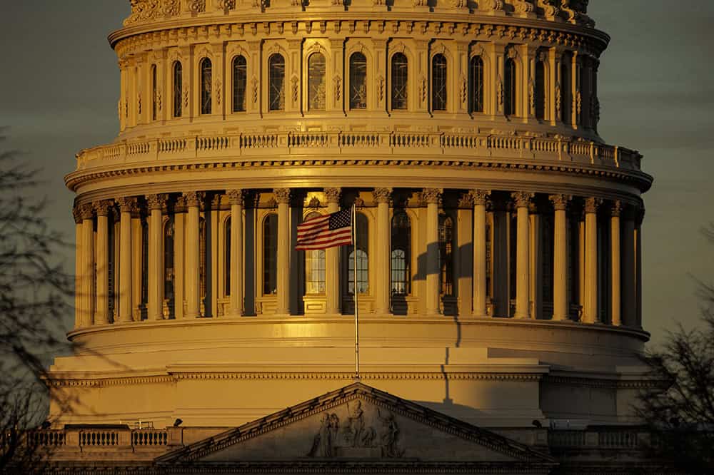 The rising sun strikes the US Capitol dome