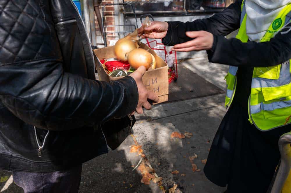 People receive food at a weekly distribution