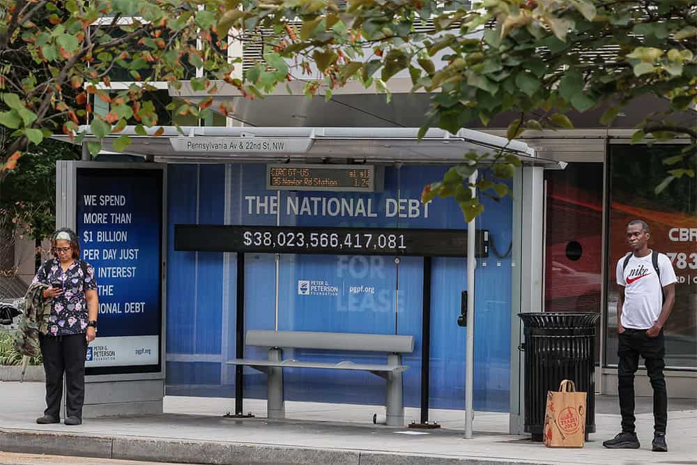 38T-DC-Bus-Shelter-Debt-Clock A view of a bus shelter at Pennsylvania Avenue and 22nd Street NW where an electronic billboard and a poster display the current U.S. National debt per person and as a nation in Washington, DC.
