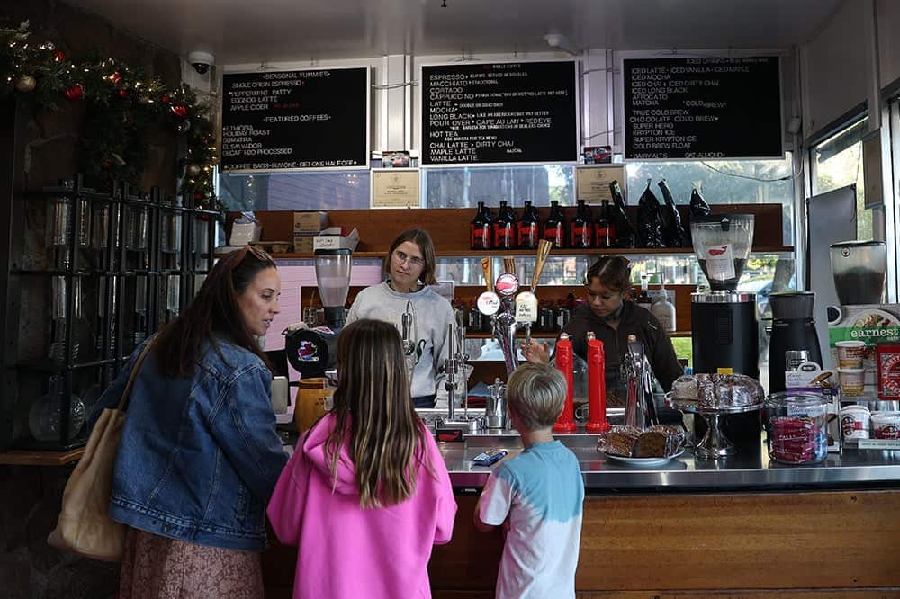 Barista helps customers